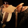 Wade tree, 15 inch seat, Gullet - 7 and 1/2 inch by 6 and 1/4 inch by 4 inch, Horn  4&1/2 inch round, 90 degree bars, 7/8ths full in-skirt riggin, Cheyenne Roll, Buckaroo outside leathers, half-breed Wade Saddle built and tooled with original floral and border design by Keith Valley.